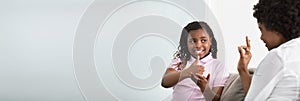 Deaf Mother Talking Sign Language With Her Daughter photo