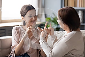 Deaf-mute adult mom and daughter talk using sign language