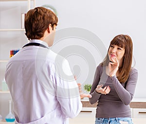 Deaf-mute female patient visiting young male doctor