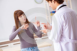 The deaf-mute female patient visiting young male doctor photo