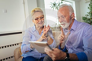 Deaf senior couple talking using sign language on the digital tablet`s cam