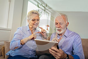 Deaf senior couple talking using sign language on the digital tablet`s cam