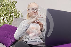 Deaf teenage girl talking gestures on laptop