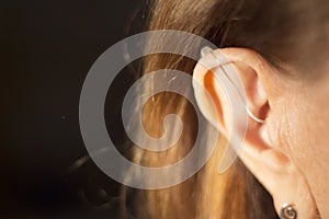 Deaf woman hearing aid ear