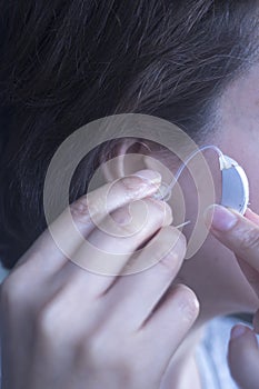 Deaf woman hearing aid ear