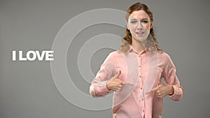 Deaf woman saying love life in sign language, text on background, communication