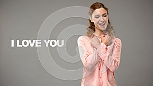 Deaf woman saying love you in sign language, text on background, communication