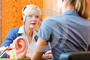 Deaf woman takes a hearing test photo