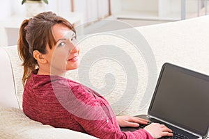 Deaf woman using laptop at home