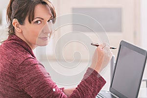 Deaf woman using laptop at home