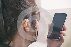 Deaf woman using smartphone