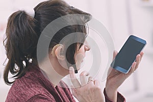 Deaf woman using smartphone