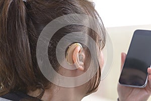 Deaf woman using smartphone