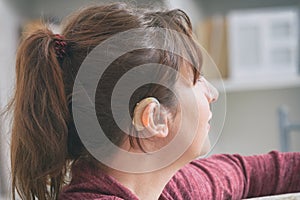 Deaf woman wearing hearing aid