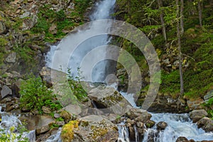 A deafening waterrfall falling from glaciers in the National Park of Great Paradise,in Piedmont,Italy