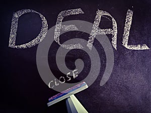 deal closed concept displaying with using stamp seal on chalkboard