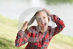 Deal with long hair on windy day. Windproof hairstyles. Girl little cute child enjoy walk on windy day nature background