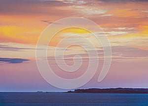 Deal Pier at dusk as a large boat passes by in the English Channel.  The image is taken the Royal Esplanade in Ramsgate, Kent,