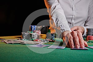 The dealer in the casino deals cards to the phonies with chips. Money, poker, success