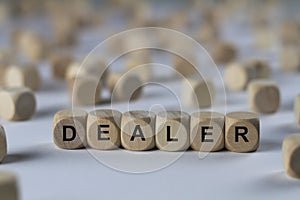 Dealer - cube with letters, sign with wooden cubes