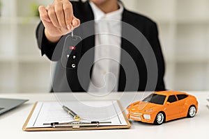 Dealer handing keys to new owners. Car sales business. Buying contracts. Customer and sales team cooperation concept after agreeme