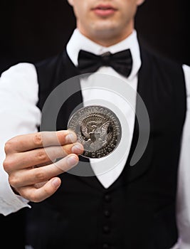 Dealer holding half dollar coin