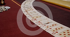 Dealer sitting in a casino at table while and distributing cards