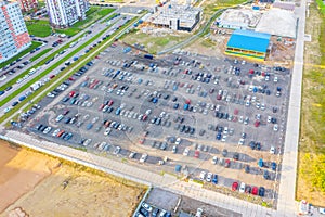 Dealership parking lot, many cars top aerial view