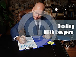 Dealing With Lawyers inscription. Closeup portrait of unrecognizable successful businessman wearing formal suit reading documents