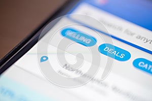 Deals button icon on shopping app on smartphone screen closeup