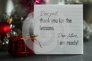 Dear past, thank you for the lessons. Dear future, i am ready. A self letter on a notepaper and red Christmas gift box.