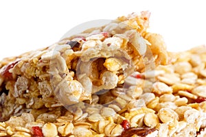 Deatail of one and half muesli bars on white. photo