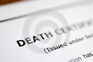 Death certificate is on table. Paperwork after death of relative