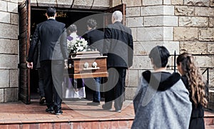 Death, funeral and people with coffin to church, chapel service and ceremony for temple ritual. RIP, mourning and burial