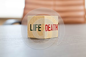 Death and Life words written on wooden block