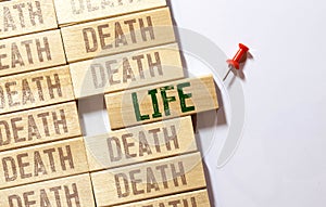 Death and Life words written on wooden block