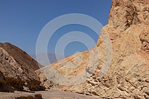 Death valley - Golden Canyon trailhead with scenic view of colorful geology of multi hued Amargosa Chaos rock formations, USA