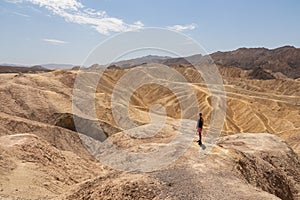 Death Valley - Man with scenic view Badlands of Zabriskie Point, Furnace creek, Death Valley National Park, California