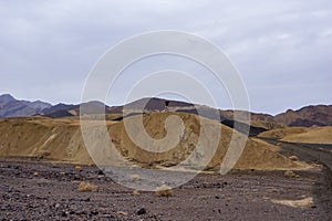 Death Valley - Man with scenic view Badlands of Zabriskie Point, Furnace creek, Death Valley National Park, California