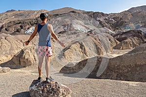 Death Valley - Man with scenic view of colourful multi hued Amargosa Chaos rock formations in Death Valley National Park, USA