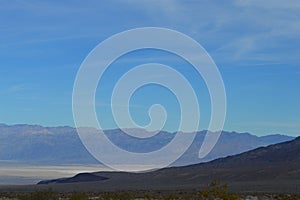 Death Valley Vista from entry point. Sloping hill foreground, mountain range and flloor in distance.