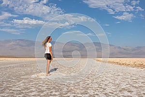 Death Valley - Woman looking at scenic view of Badwater Basin salt flats in Death Valley National Park, California, USA