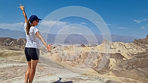 Death Valley - Woman with scenic view Badlands of Zabriskie Point, Furnace creek, Death Valley National Park, California