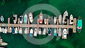 Deatil of pier with boats and yachts from above by drone