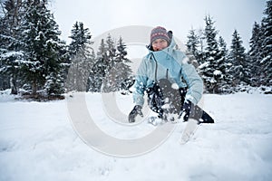 Deatil shot of woman throwing snow into point of view.