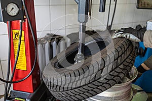 Debeading a car tire at service station