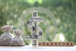 Debenture word with usd dollar money on natural green background, Investments and Debenture concept