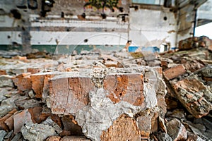 Debris of bricks in ruins of the destroyed factory building inside