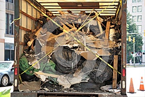 Enclosed truck filled with broken charred trash and wood photo