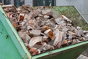 Debris in a green metal container.